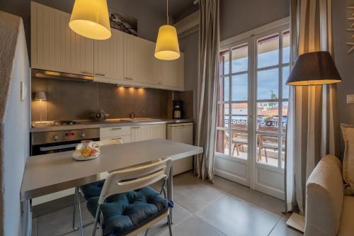 a kitchen with a table with two chairs and a window at Filina House in Neos Marmaras