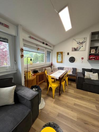 a living room with a couch and a table at Piancavallo Loft - Garage & View in Piancavallo