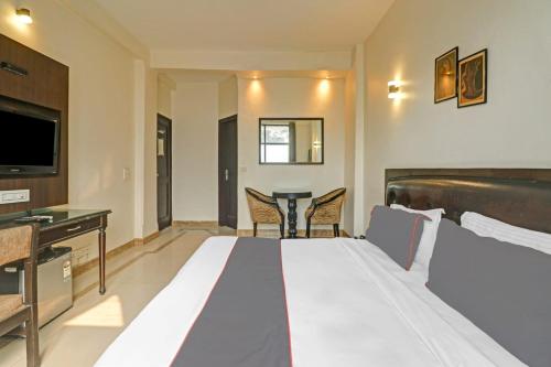 a hotel room with a bed and a table at Hotel Lloyd Near Kalkaji Temple in New Delhi