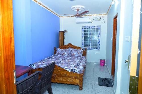 a bedroom with a bed and a ceiling fan at SRIVALLI Lodge in Avanigadda