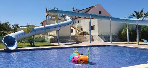 a water slide in a swimming pool at Sofiamarholidays O Cantinho da Avó Bina in Moita