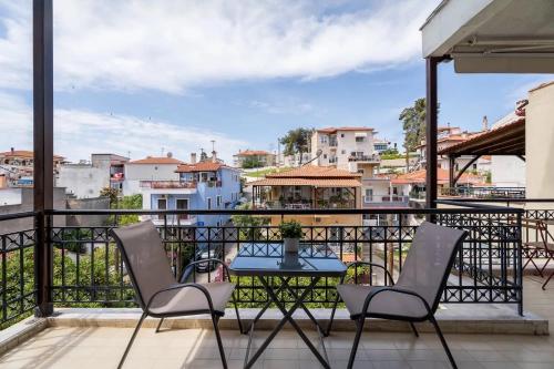 a balcony with a table and chairs and a view at Filina House in Neos Marmaras