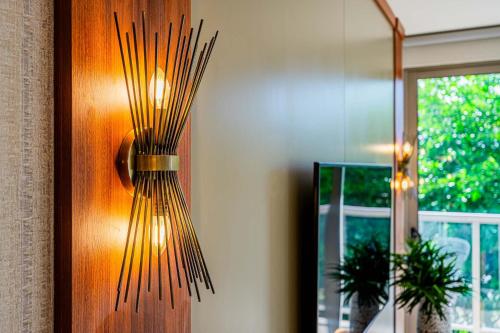 a light on a wooden door with a window at Glorious 1BR with Balcony in Panama Pacifico in Playa Bonita Village