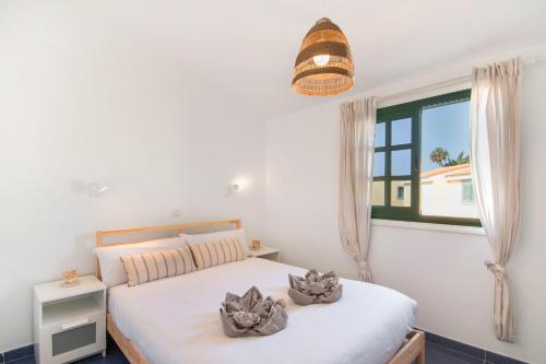 a bedroom with two beds and a window at Bungalow Parrales Maspalomas in Maspalomas