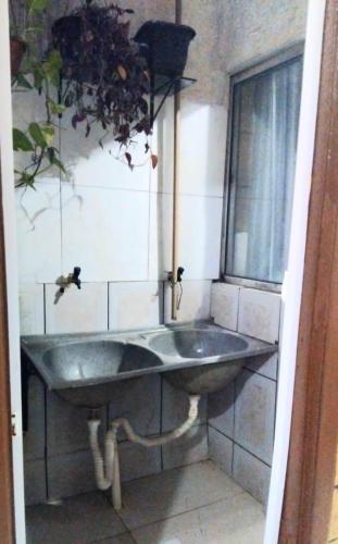 a bathroom with a sink and a window at Casa COP Maria bonita in Belém