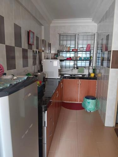 a kitchen with a sink and a counter top at HomestayP11 in Putrajaya