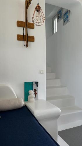 a bedroom with a bed and a stair case at Myconian Theros Luxury Suites in Ano Mera