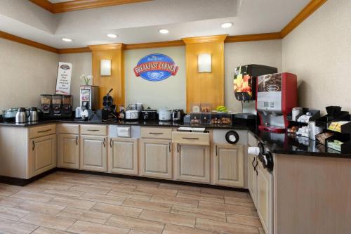 a kitchen with a counter top with a coffee maker at Baymont by Wyndham Paw Paw in Paw Paw