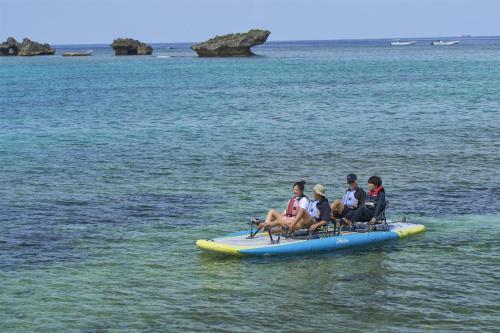 a group of people sitting on a raft in the water at Hyatt Regency Seragaki Island Okinawa in Onna