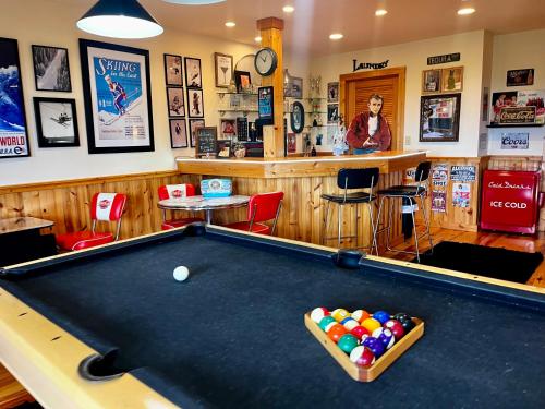 a billiard table in a pub with a bar at Sky High by Carolina Mornings in Swiss