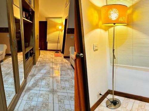 a hallway with a lamp and a tile floor at สวนไมตรีจิต รีสอร์ท in Ban Khlong Si