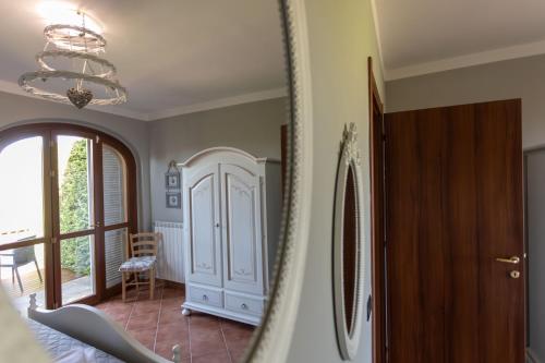 a room with a hallway with a chandelier at CS Holiday in Castelnuovo Berardenga