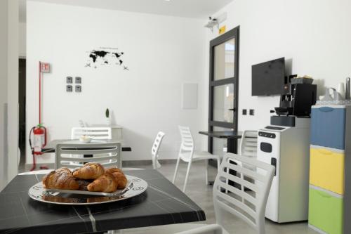 a table with a plate of bread on top of it at Dream's Rooms Salemi in Ulmi