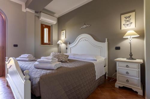 a bedroom with a large bed with towels on it at CS Holiday in Castelnuovo Berardenga