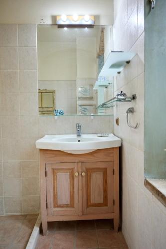 a bathroom with a sink and a mirror at Kampos Mansion 1 in Chios