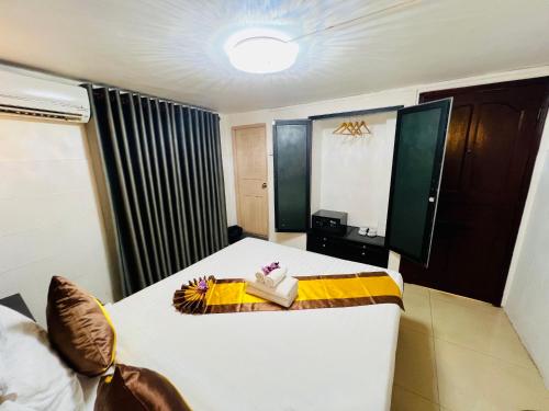 a hotel room with a bed with a yellow and white at Sun Chakra Boutique Hotel - 50m to Museum & Royal Palace & Walking street in Phnom Penh