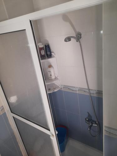 a shower in a bathroom with a blue and white at إقامة شمس 24 in Martil