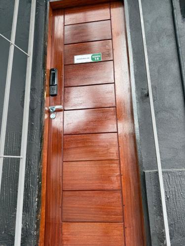 a wooden door on the side of a building at Hotel e Restaurante Casa Paraense Original, px ao aeroporto in Manaus