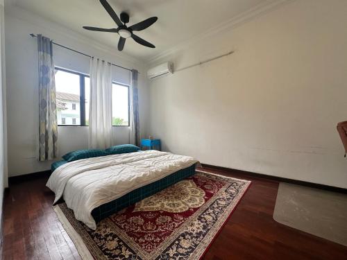 a bedroom with a bed and a ceiling fan at Casa Blanca R2 in Cyberjaya