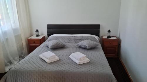 a bedroom with a bed with two towels on it at Wine Garden old apartment with large terrace in Skradin