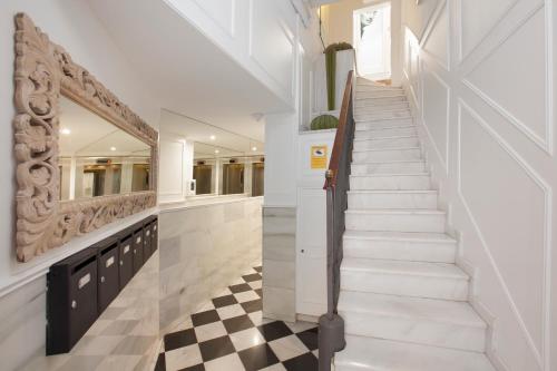 a staircase in a house with a checkered floor at Enjoybcn Dali Apartments in Barcelona