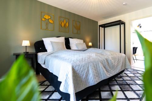 a bedroom with a bed with a white comforter at Apartment Maro - nahe Basel in Grenzach-Wyhlen