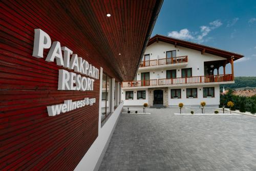 a large building with a red and white facade at Pensiunea Patakparti 4 in Praid