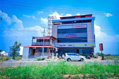 a building with a car parked in front of it at G P Comforts in Chikmagalūr