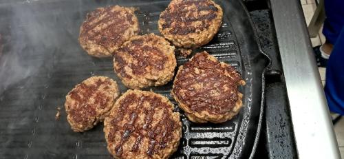 a group of hamburgers cooking on a grill at Il Sentiero in Acquapendente