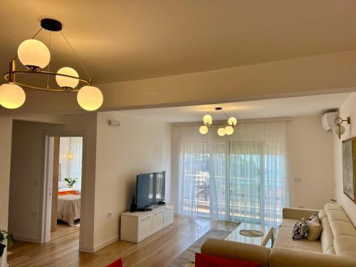 a living room with a couch and a tv at Apartments Gazi in Ulcinj