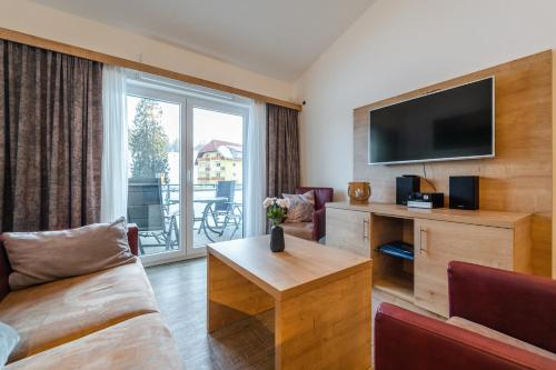 a living room with a couch and a tv at Apartment 311 in Feldberg