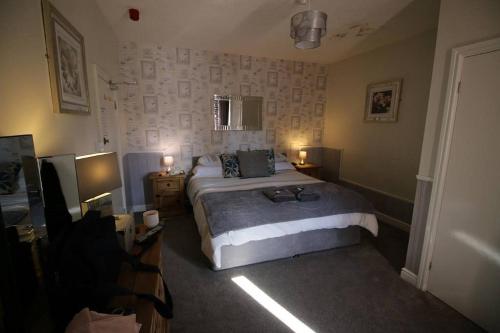 a bedroom with a bed and two lamps and a television at Stanley Arms in Holyhead