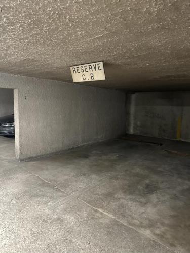 an empty parking garage with a rescue sign on the ceiling at Suite Montrachet 4 personnes vue cathédrale 1 Place de parking in Dijon