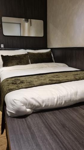 two beds sitting next to each other in a room at Highwind - Projector, Playstation 4, Pool in Silang