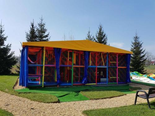 a play tent with a playground in a park at Domek Bomba Zator Graboszyce in Graboszyce