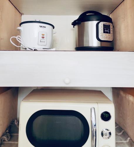 a microwave and a slow cooker on top of a refrigerator at The Mod Pod in Eugene