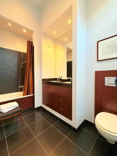 a bathroom with a toilet and a sink at Bourgogne Suite Maastricht in Maastricht