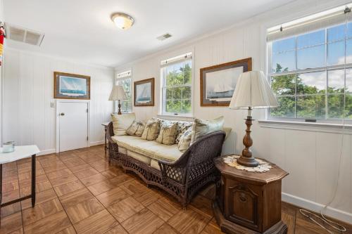 a living room with a couch and two windows at Berry Restful home in Georgetown