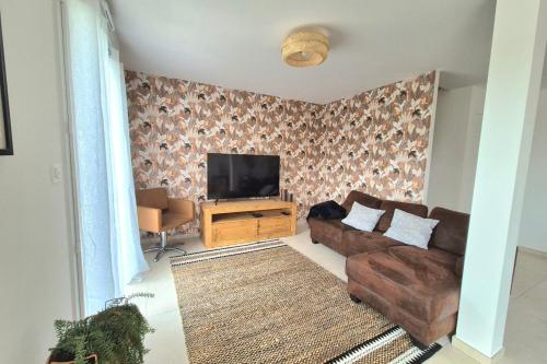 a living room with a couch and a flat screen tv at Beautiful 3 bedroom house close to the sea in Cherrueix
