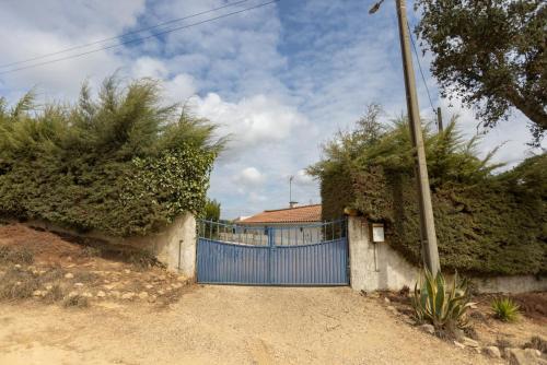 a blue gate in front of a house at Monte dos Casarões Casa grande in São Luis