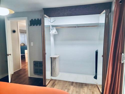 a room with a sliding glass door with a closet at The Mod Pod in Eugene