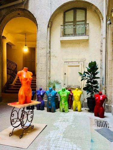 a group of colorful vases in front of a building at Le Yellow - Hôtel Particulier XIXème in Montpellier