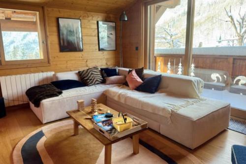 a living room with a couch and a table at Family chalet in Chamonix Tour-Argentiere in Chamonix-Mont-Blanc