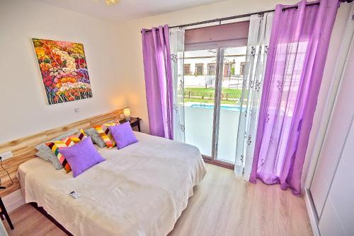 a bedroom with purple curtains and a bed and a window at Jacuzzi & Pool House w Rooftop Terrace, Garden BBQ in El Puerto de Santa María