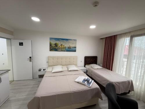 a hotel room with two beds and a window at ELİSA Park Hotel in Trabzon