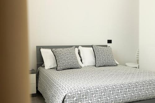 a bedroom with a large bed with four pillows at Dream's Rooms Salemi in Ulmi