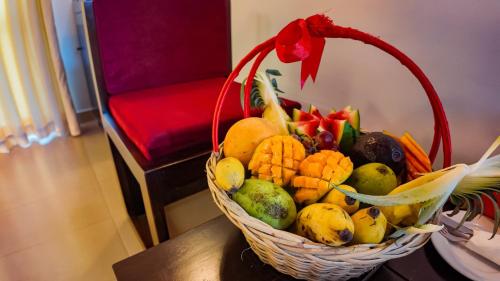 a basket of fruit and vegetables on a table at Hotel Kamrel Sigiriya in Sigiriya