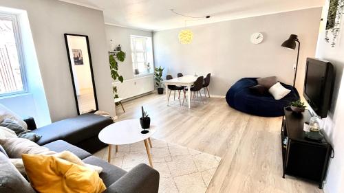 a living room with a couch and a table at Apartment Alma - Cosy Stay in Aalborg C in Aalborg