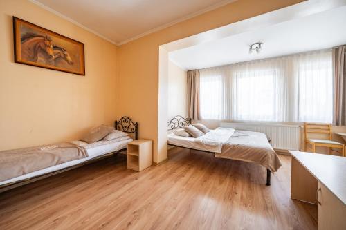 a room with two beds and a table at Pokoje u Beaty in Zakopane