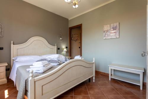 a bedroom with a bed with towels on it at CS Holiday in Castelnuovo Berardenga